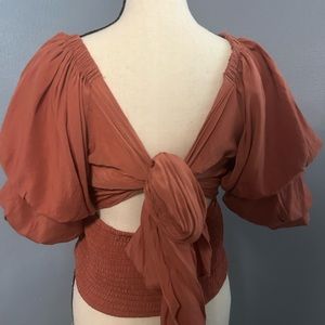 Burnt orange, size medium. Worn one time, very comfortable!